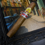 Cigar with a label in front of a framed picture of a street scene. Bolívar Libertador Regional Edition France 