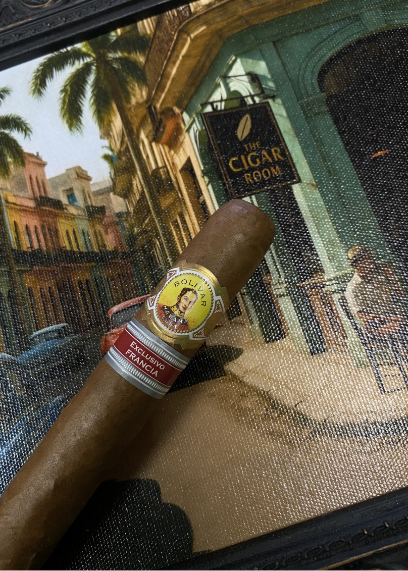 Cigar with a label on a decorative tray featuring a cityscape. Bolívar Libertador Regional Edition France 