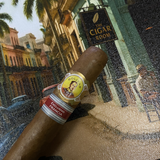 Cigar with a label on a decorative tray featuring a cityscape. Bolívar Libertador Regional Edition France 