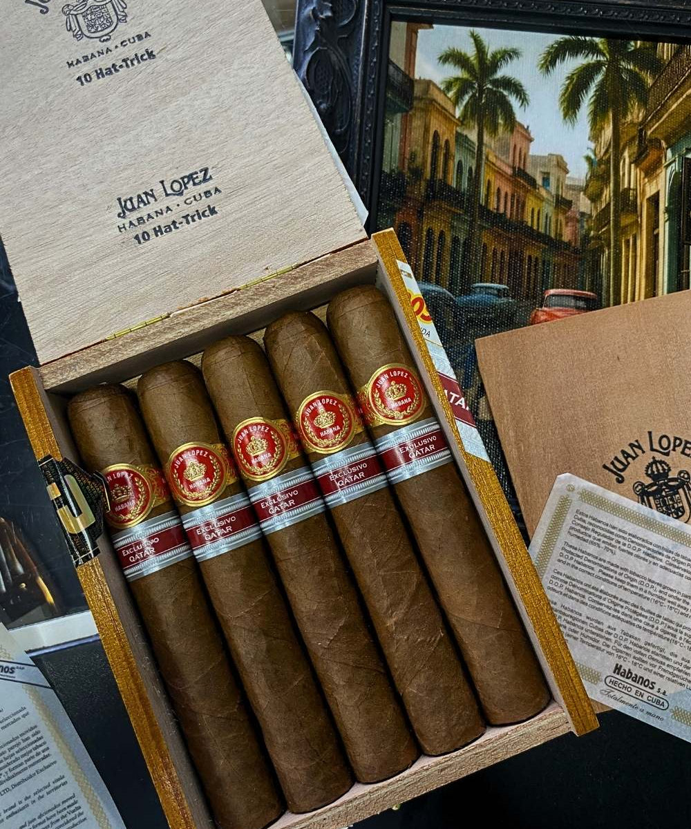 Box of Juan Lopez cigars with a scenic painting in the background