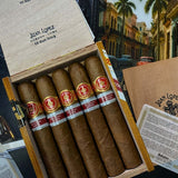 Box of Juan Lopez cigars with a scenic painting in the background