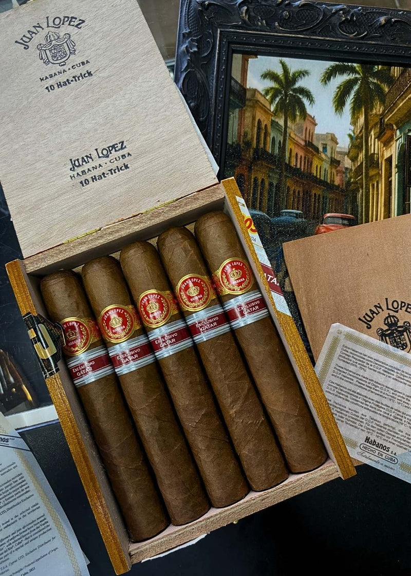 Box of Juan Lopez cigars with a scenic painting in the background
