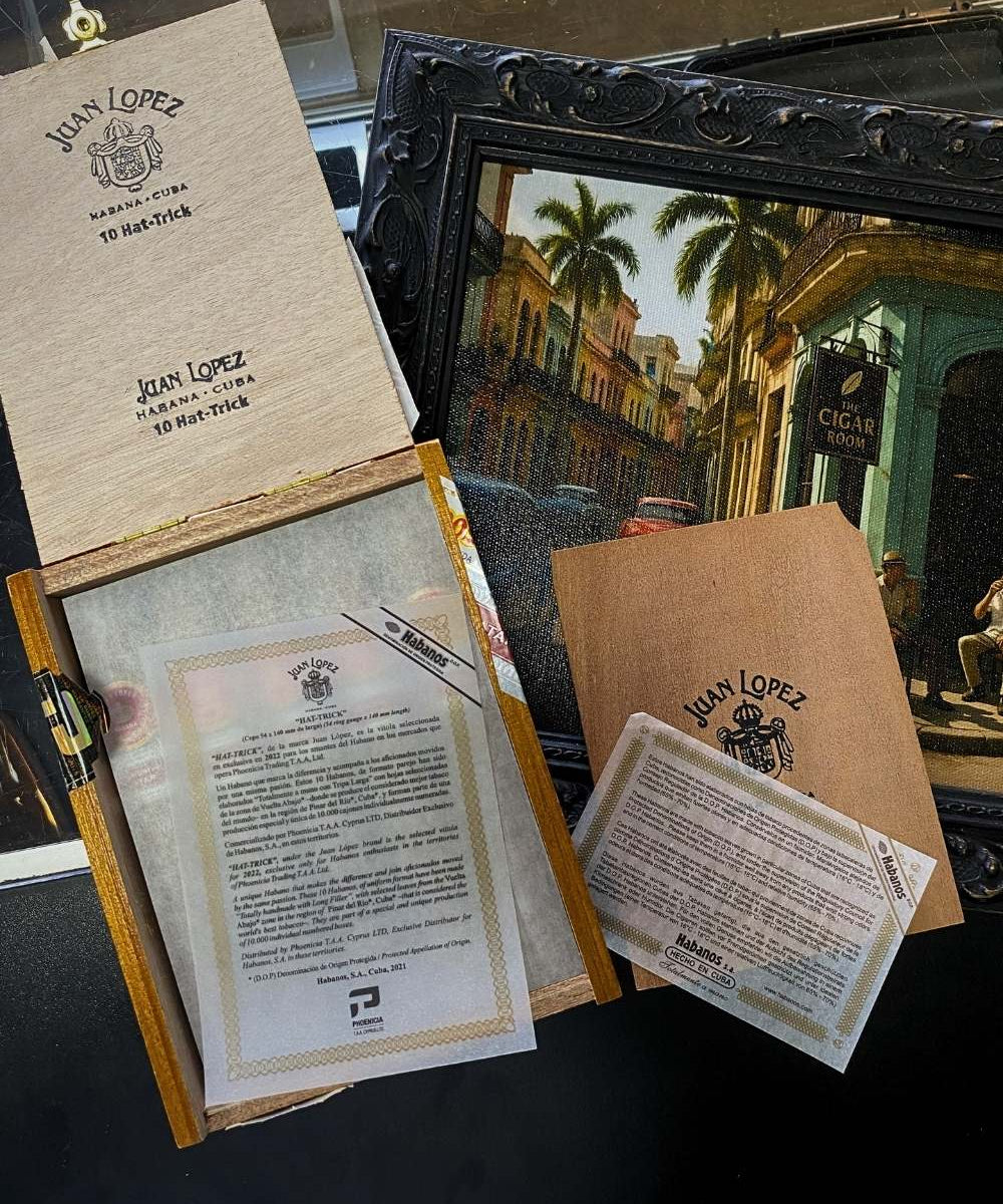Collection of Juan Lopez documents and a framed painting on a dark surface
