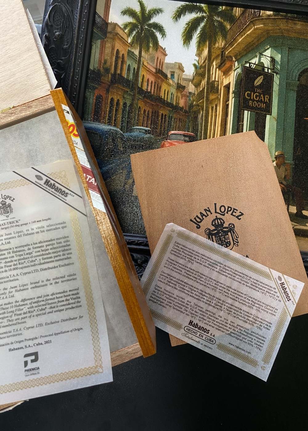 Cigar packaging with brand labels and a scenic background