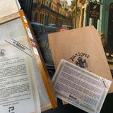Cigar packaging with brand labels and a scenic background