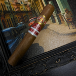 Cigar with a brand label in front of a painting of a city street scene. Ramón Allones Sr. Henry Regional Edition Germany 2020 