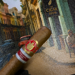 Cigar with a red band in front of a painting of a street scene. Saint Luis Rey Marquéz Regional Edition Exclusive Cuba 2016