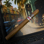 Cigar with a brand label on a decorative background of a street scene. Sancho Panza Quijote Regional Edition Spain